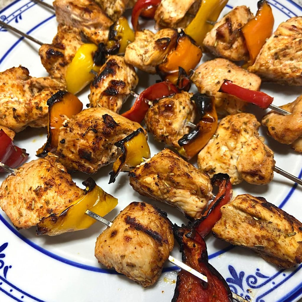 Grilled chicken kabobs on plate ready to eat