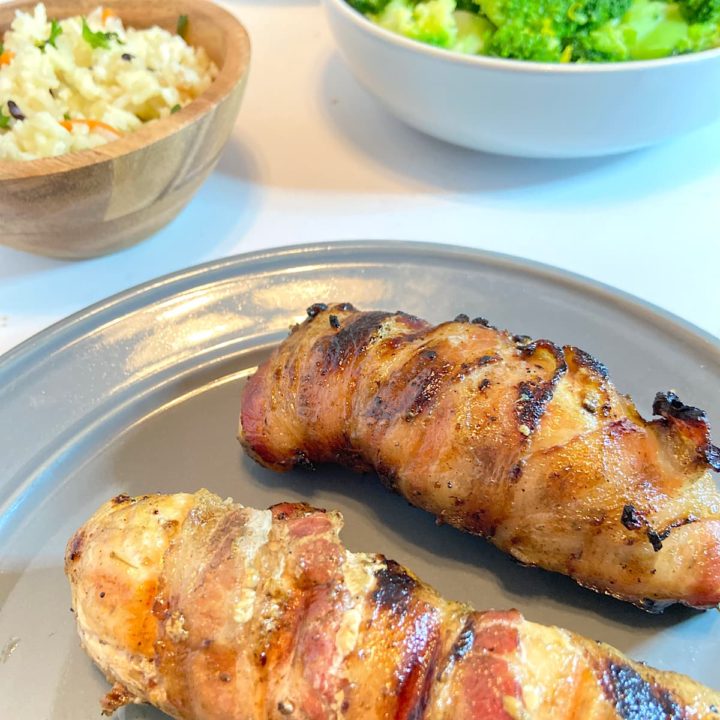 bacon wrapped grilled chicken breasts on plate