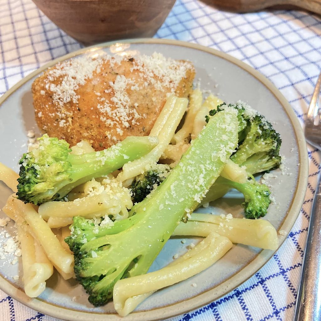 pasta and broccoli on a plate with chicken parmesan