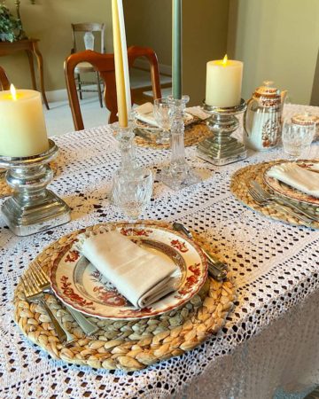 Table set with place settings, flatware, and glasses for a holiday meal