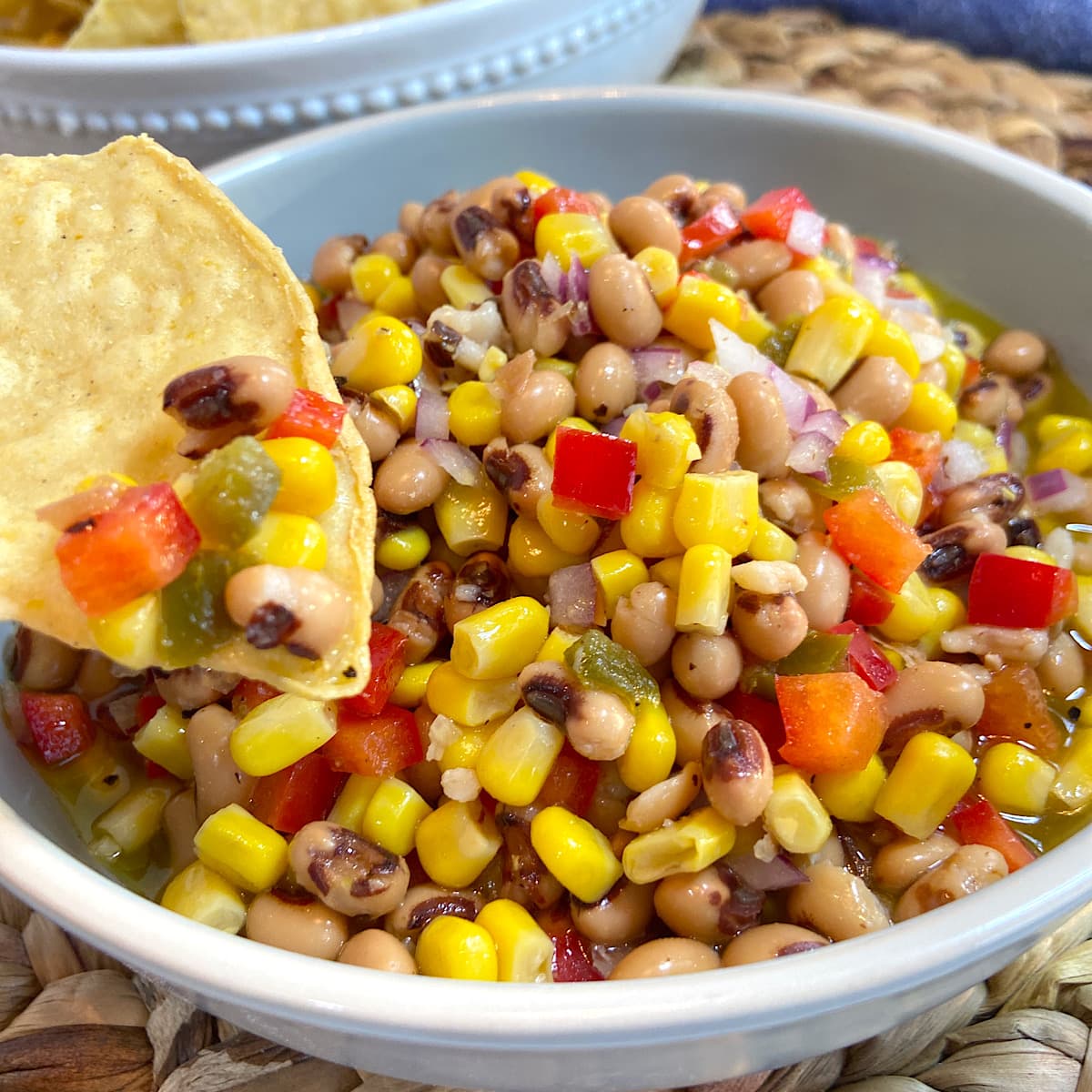 corn and black eyed pea dip with a chip.
