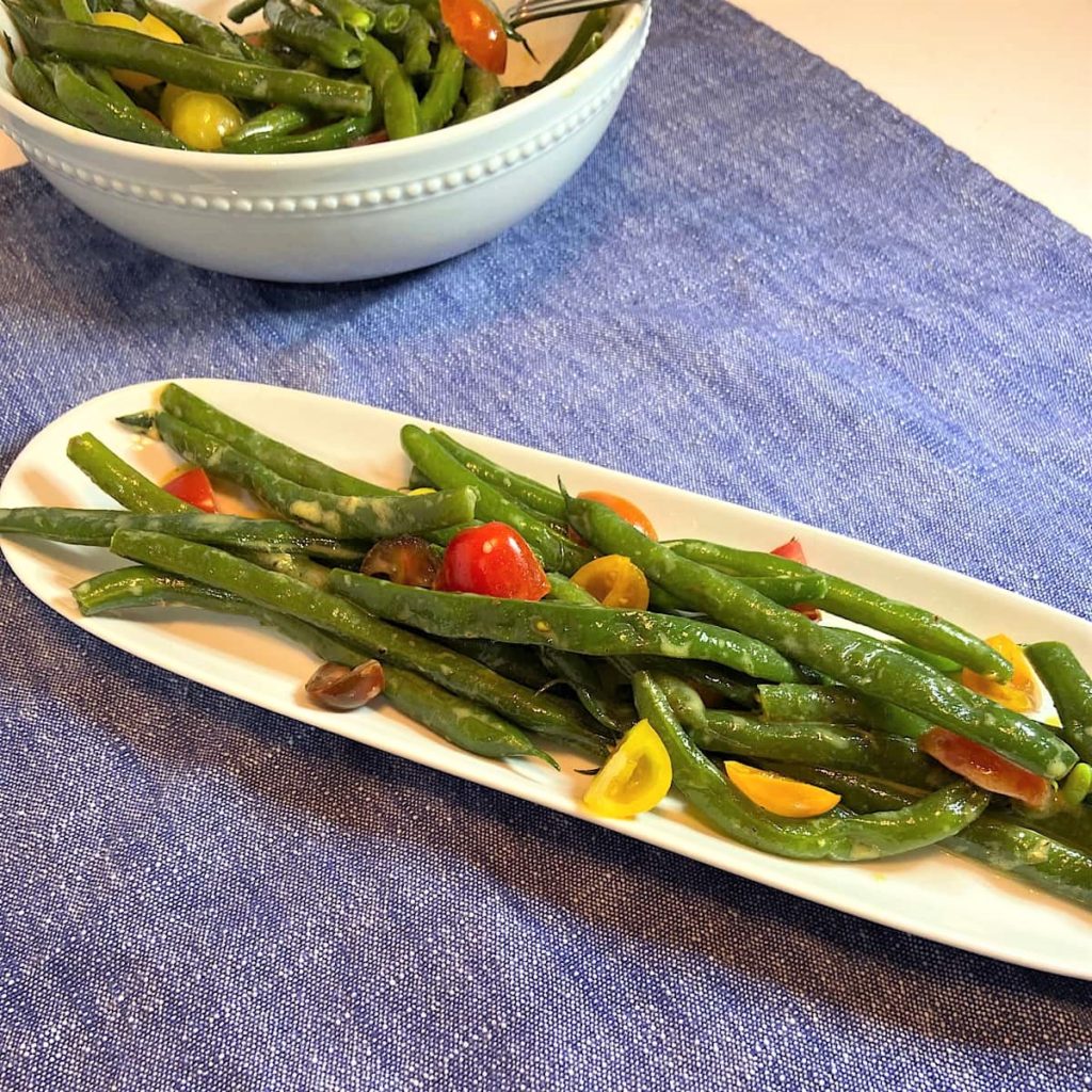 Green beans tomatoes ready to serve on plate