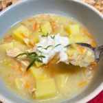 chicken potato soup in bowl with dollop of sour cream
