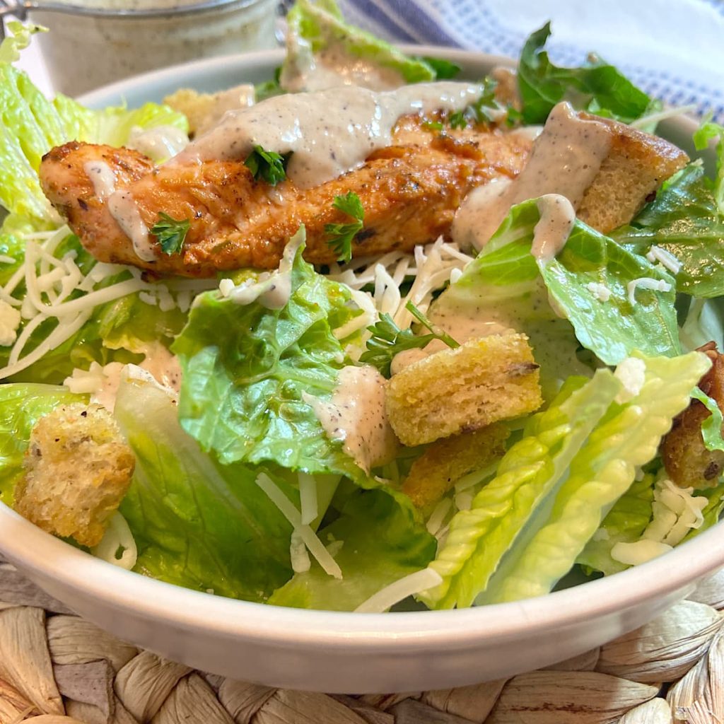 grilled chicken caesar salad in bowl