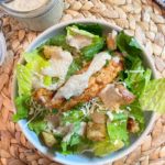 grilled chicken caesar salad with mayfair dressing in bowl