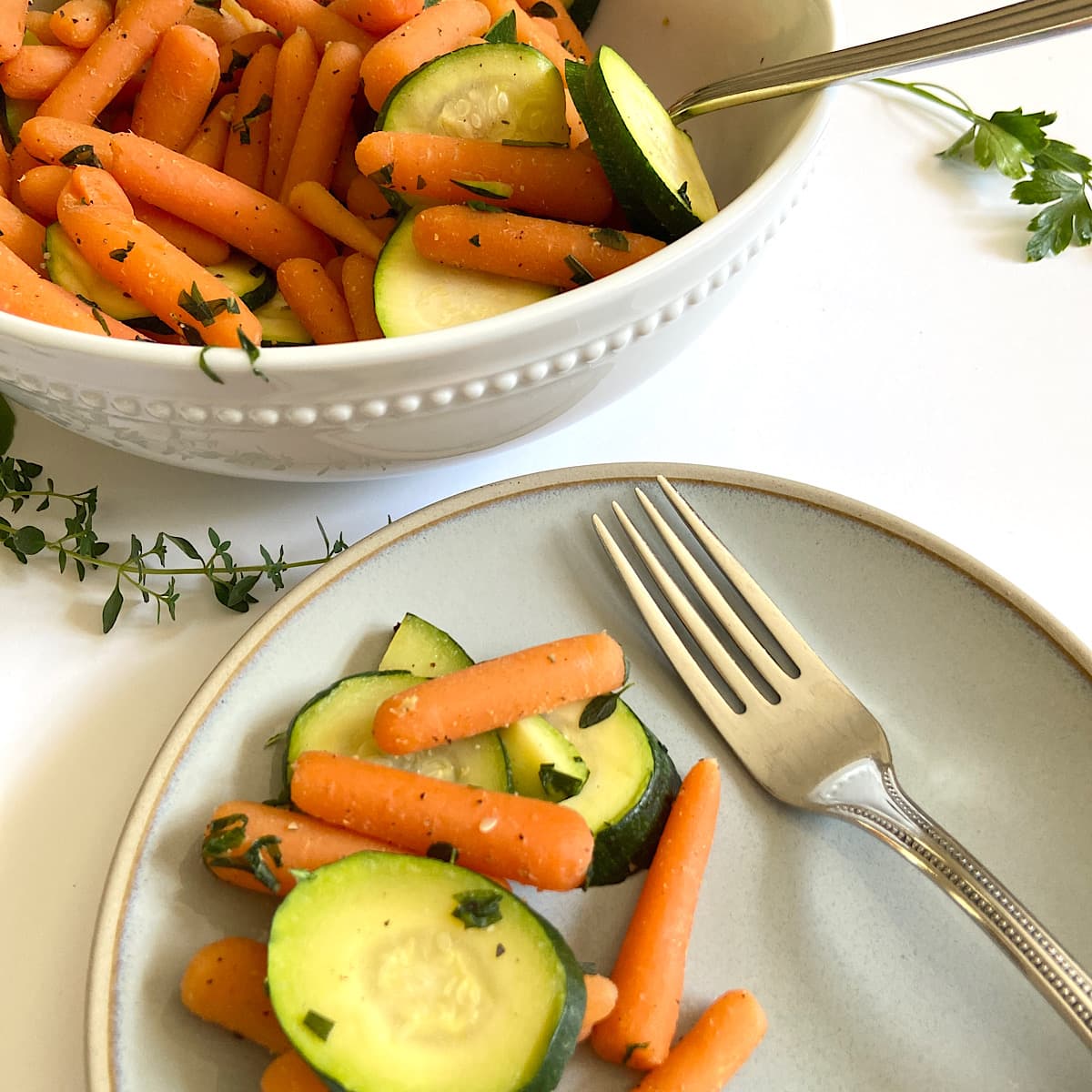 baby carrots with zucchini on plate and in bowl