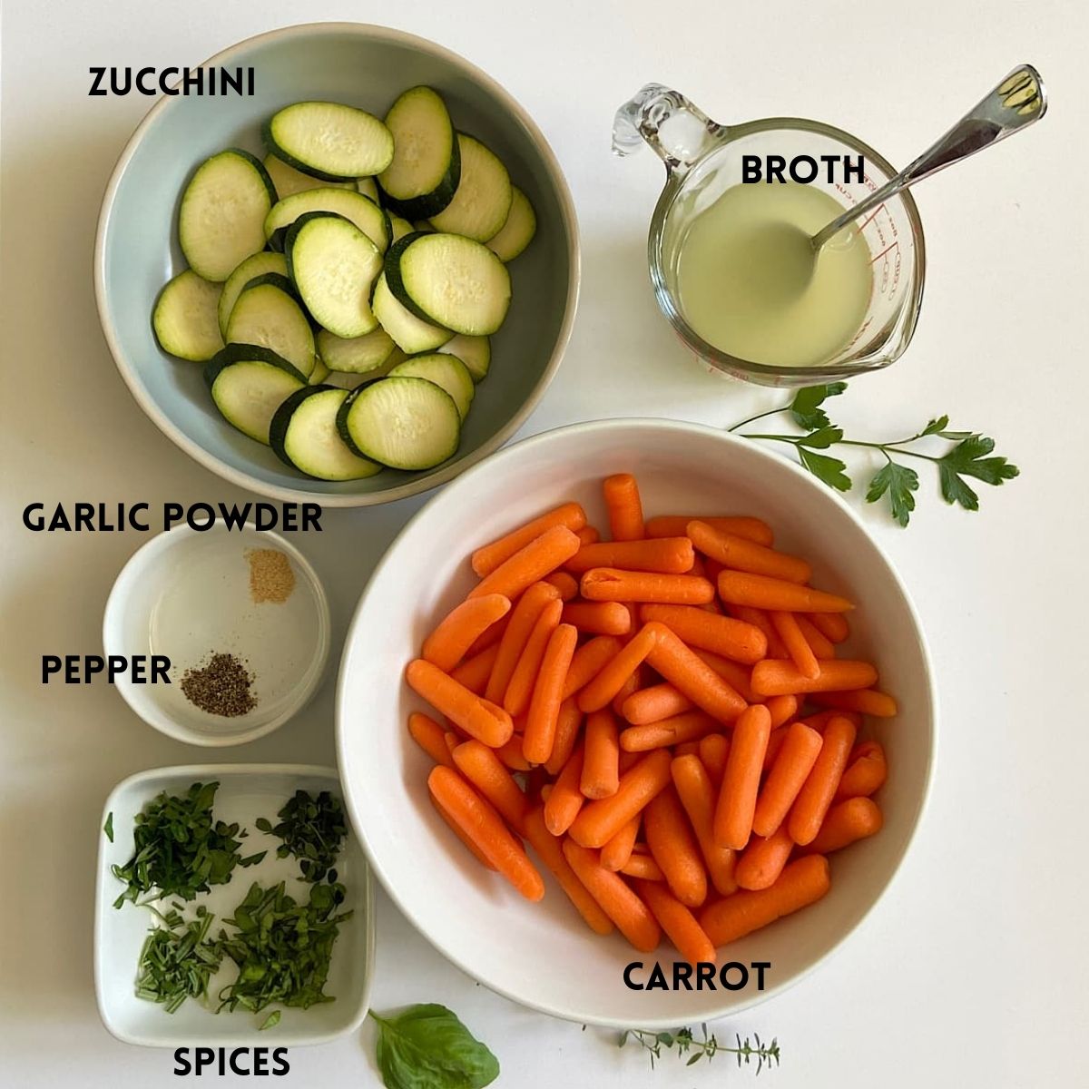 Measured ingredients for baby carrots with zucchini