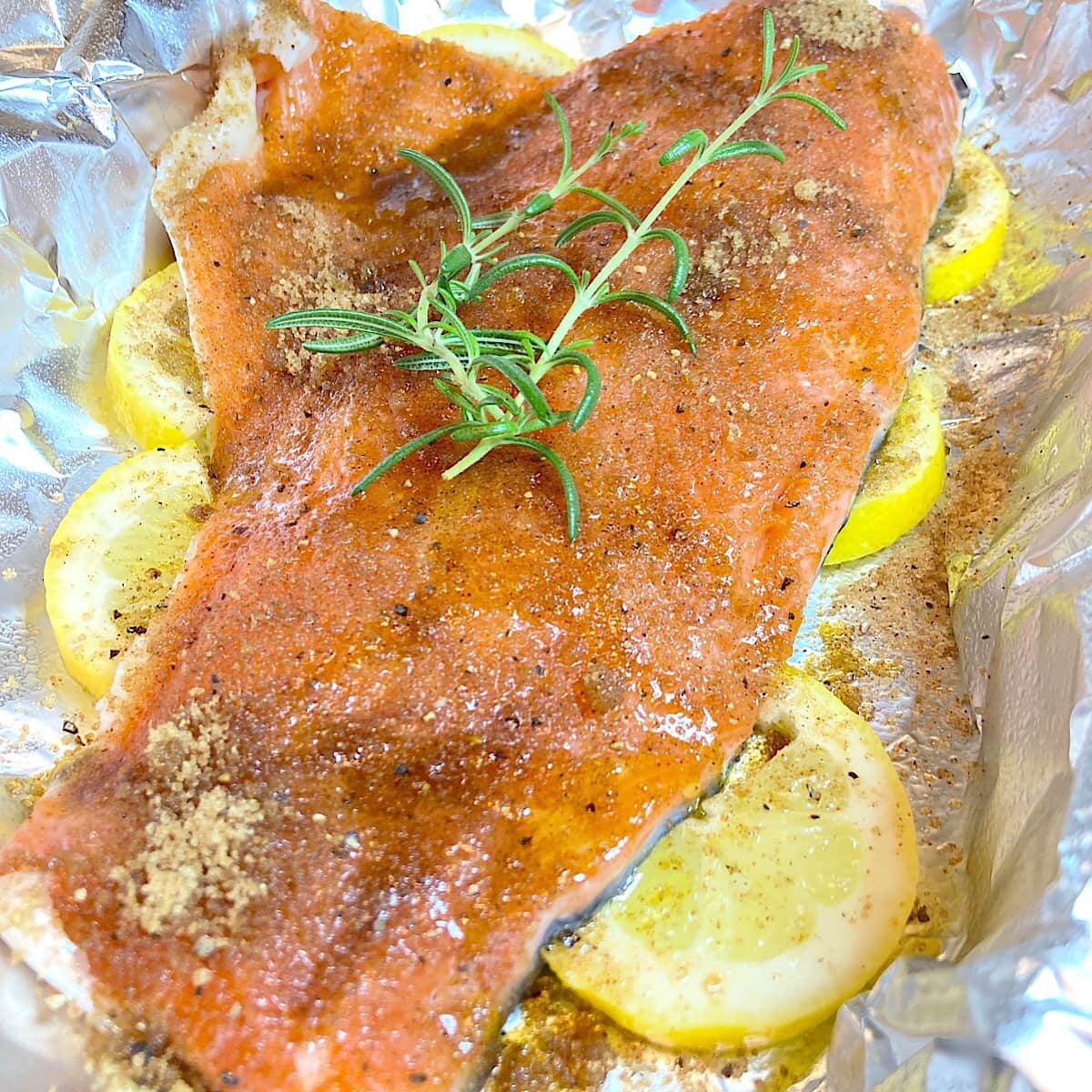 salmon filet on lemon drizzled with olive oil and spices.