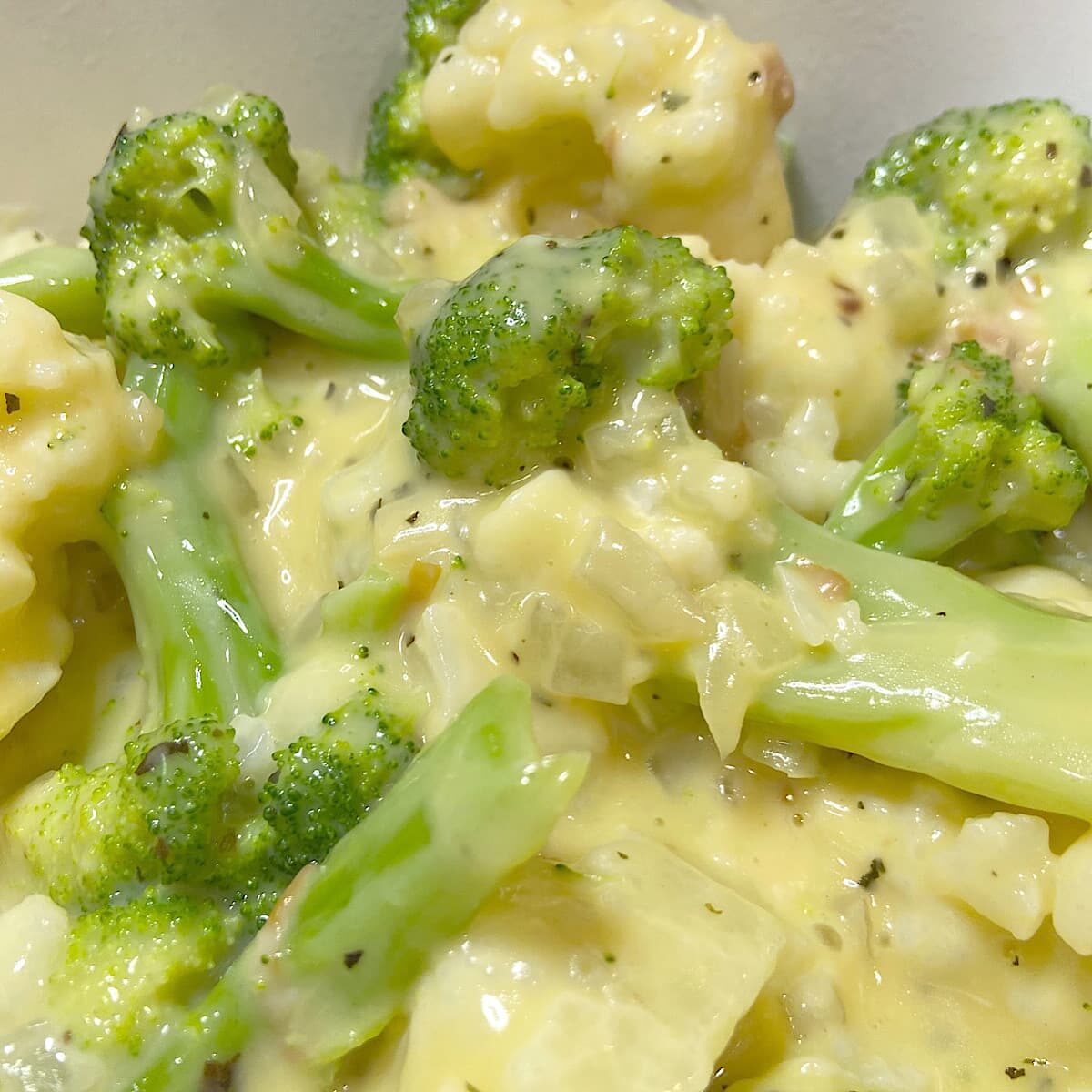 picture of cooked broccoli and cauliflower in gouda cheese sauce.