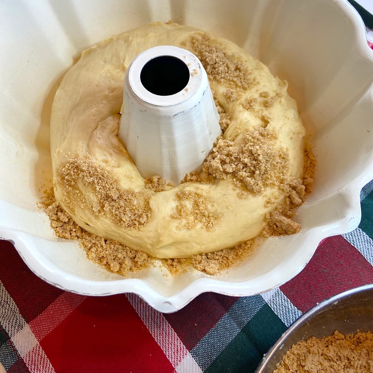 cinnamon roll coffe cake dough in pan with crumb toppint