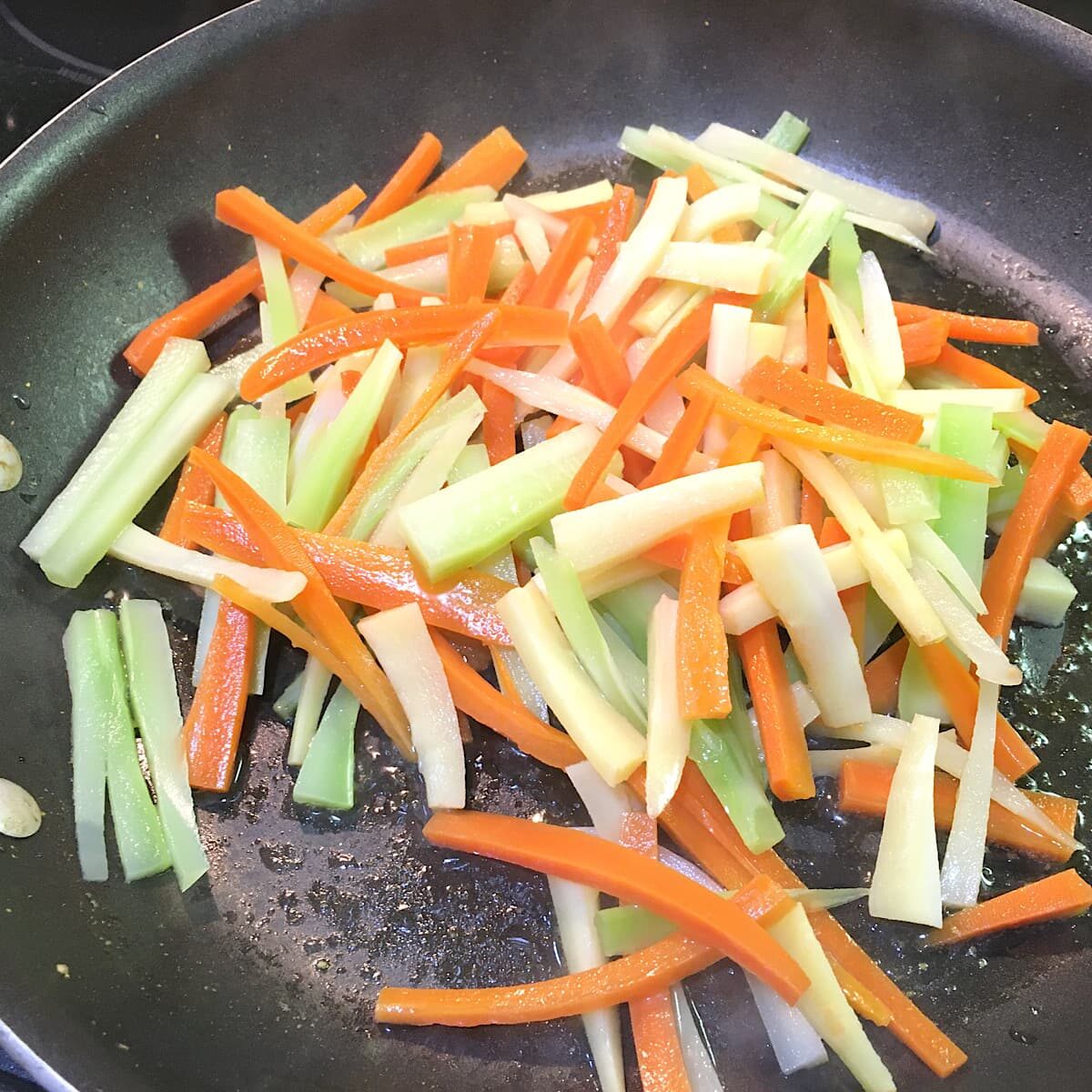 julienned veggies in frying pan.