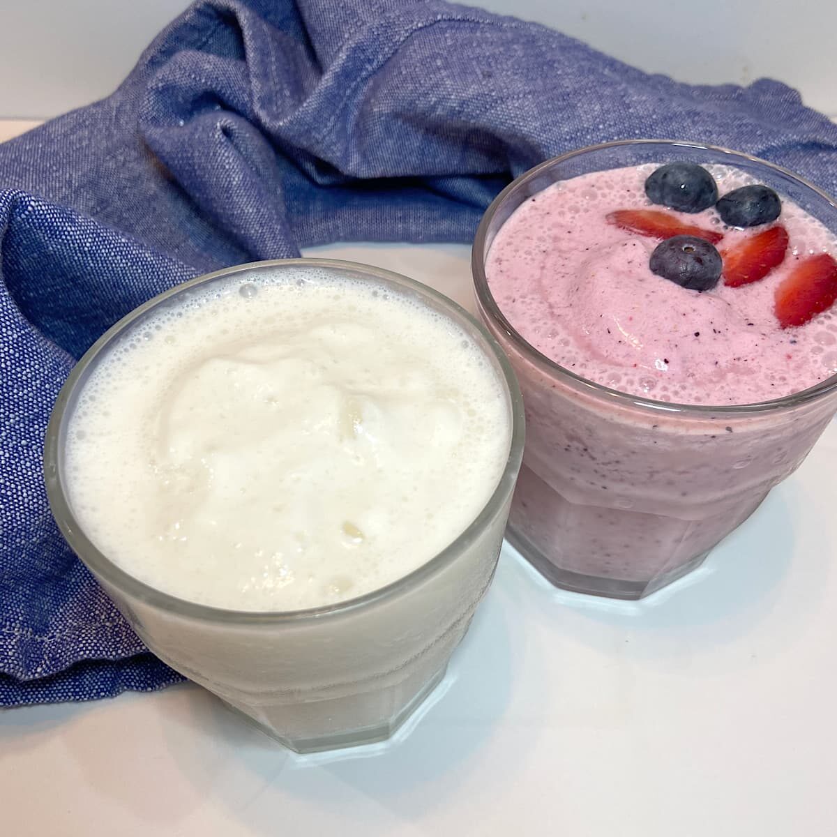 vanilla and strawberry blueberry smoothies in glasses