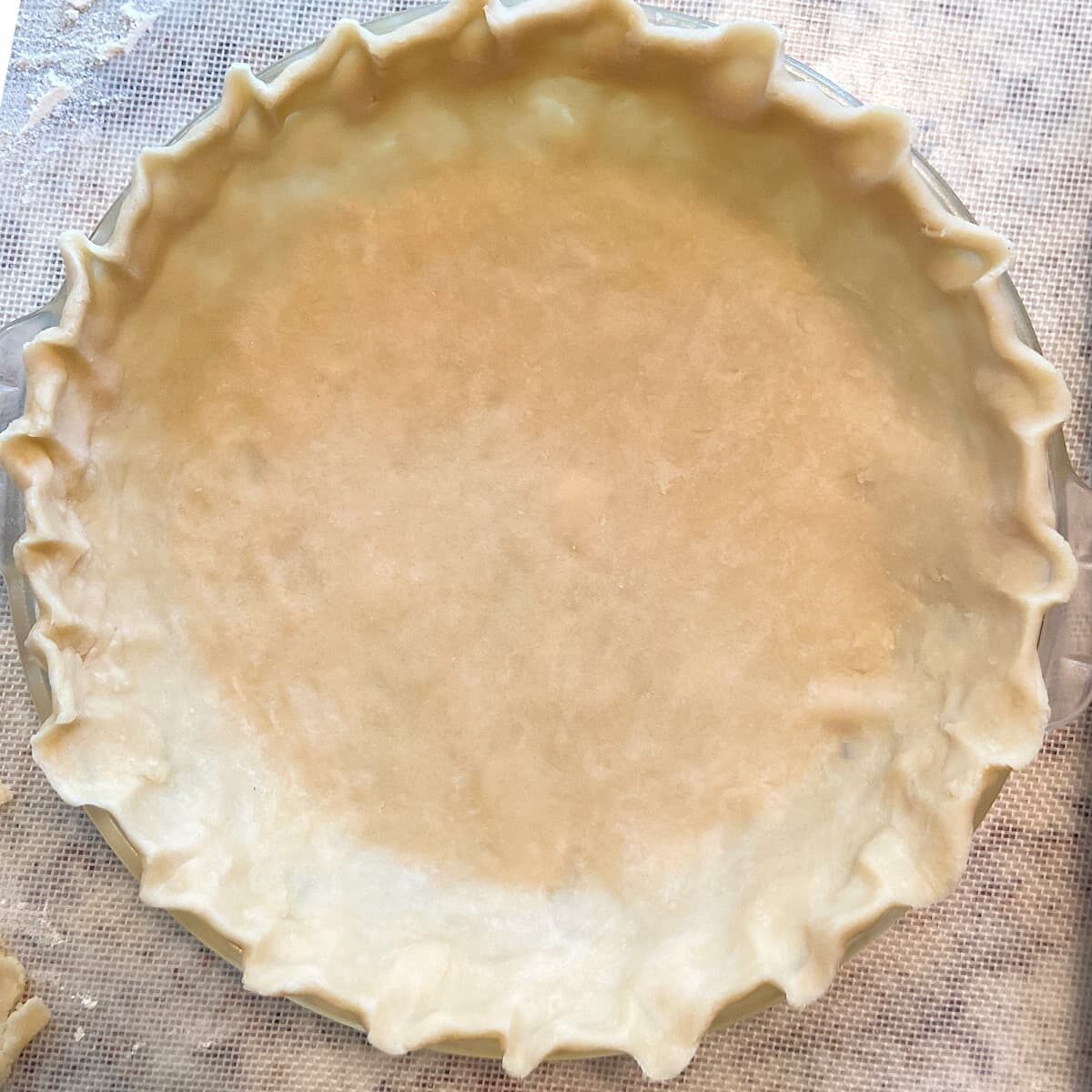 crimped pie crust dough in dish