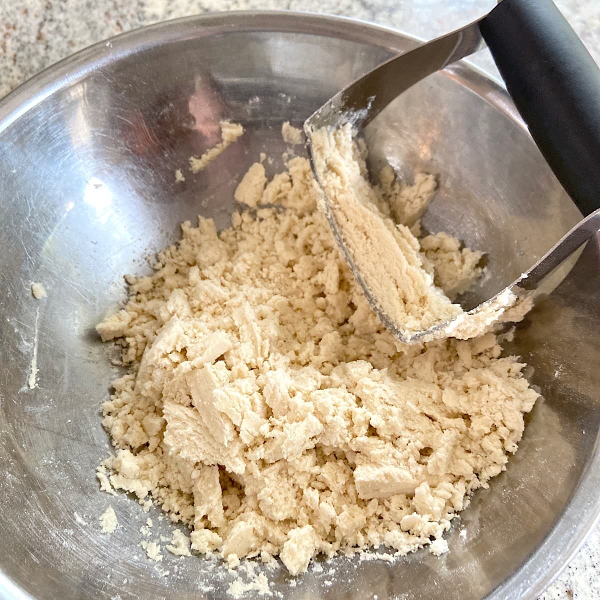 crust crumbs in bowl with pastry blender