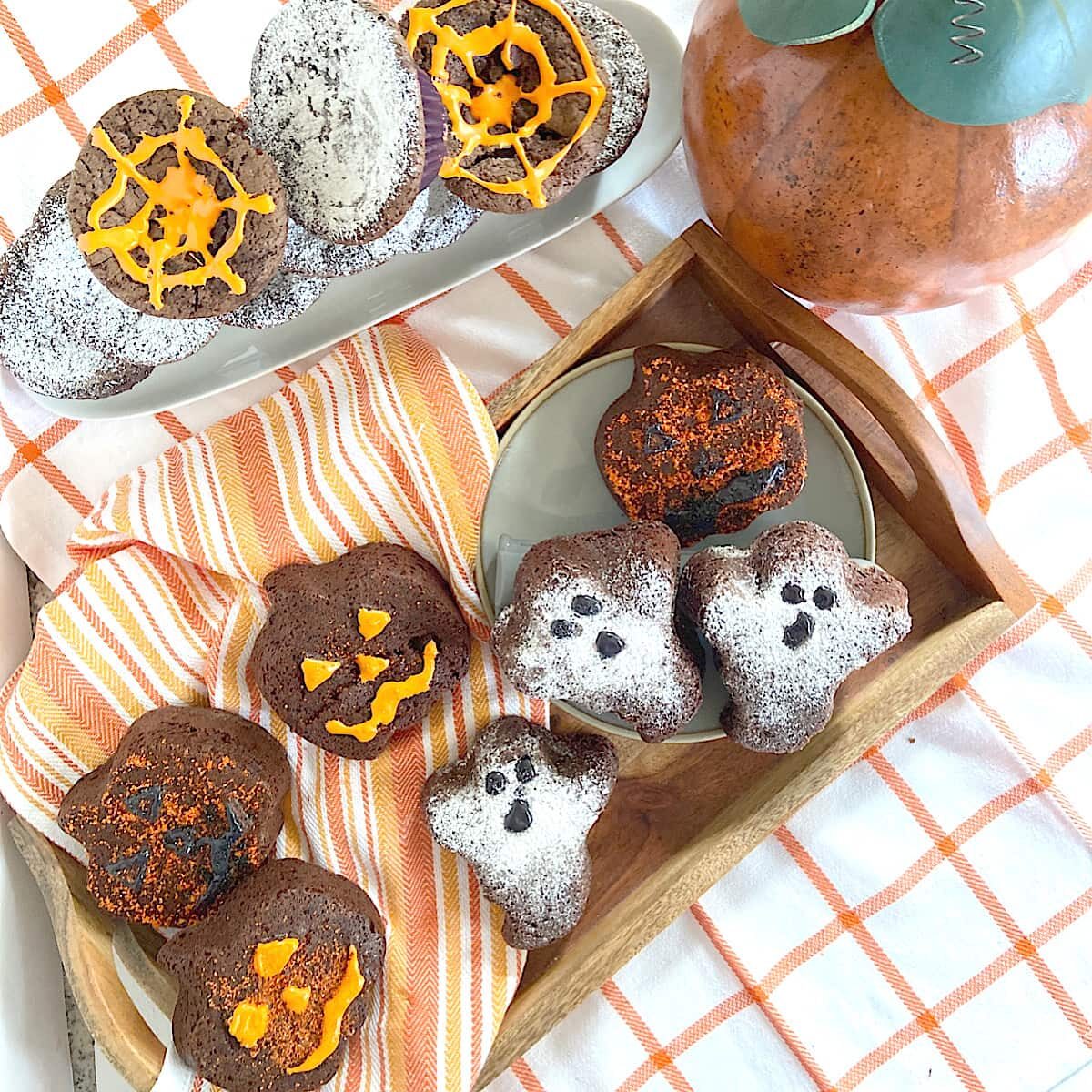 Halloween shaped brownies decorated with powdered sugar and icing.