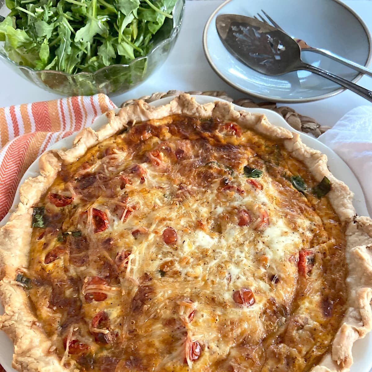Fresh baked quiche with arugula salad