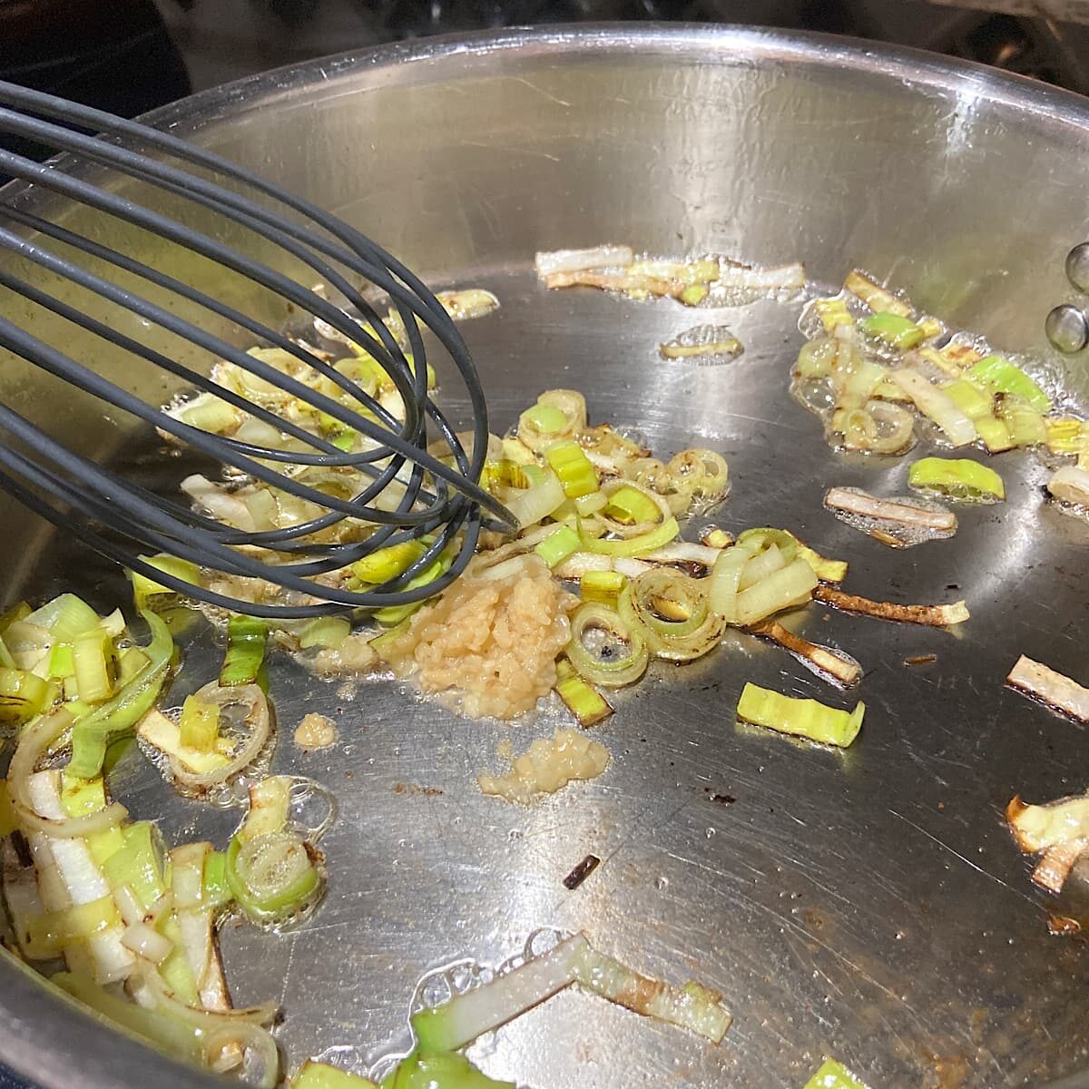 Add garlic to leeks and stir and cook