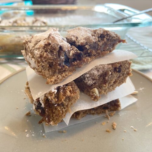stacked almond and prune snack bars on plate.