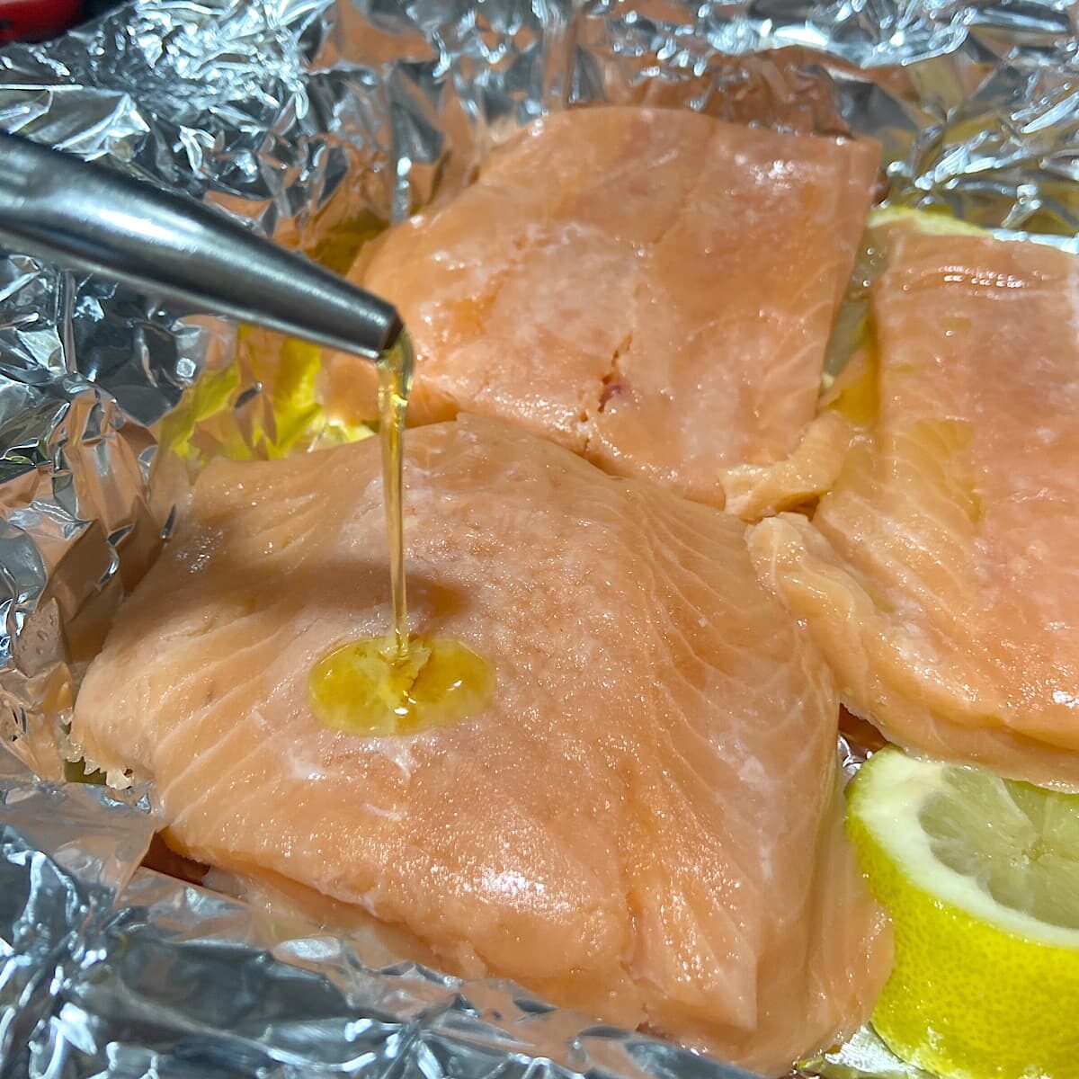 drizzle salmon filets with olive oil and rub to coat.