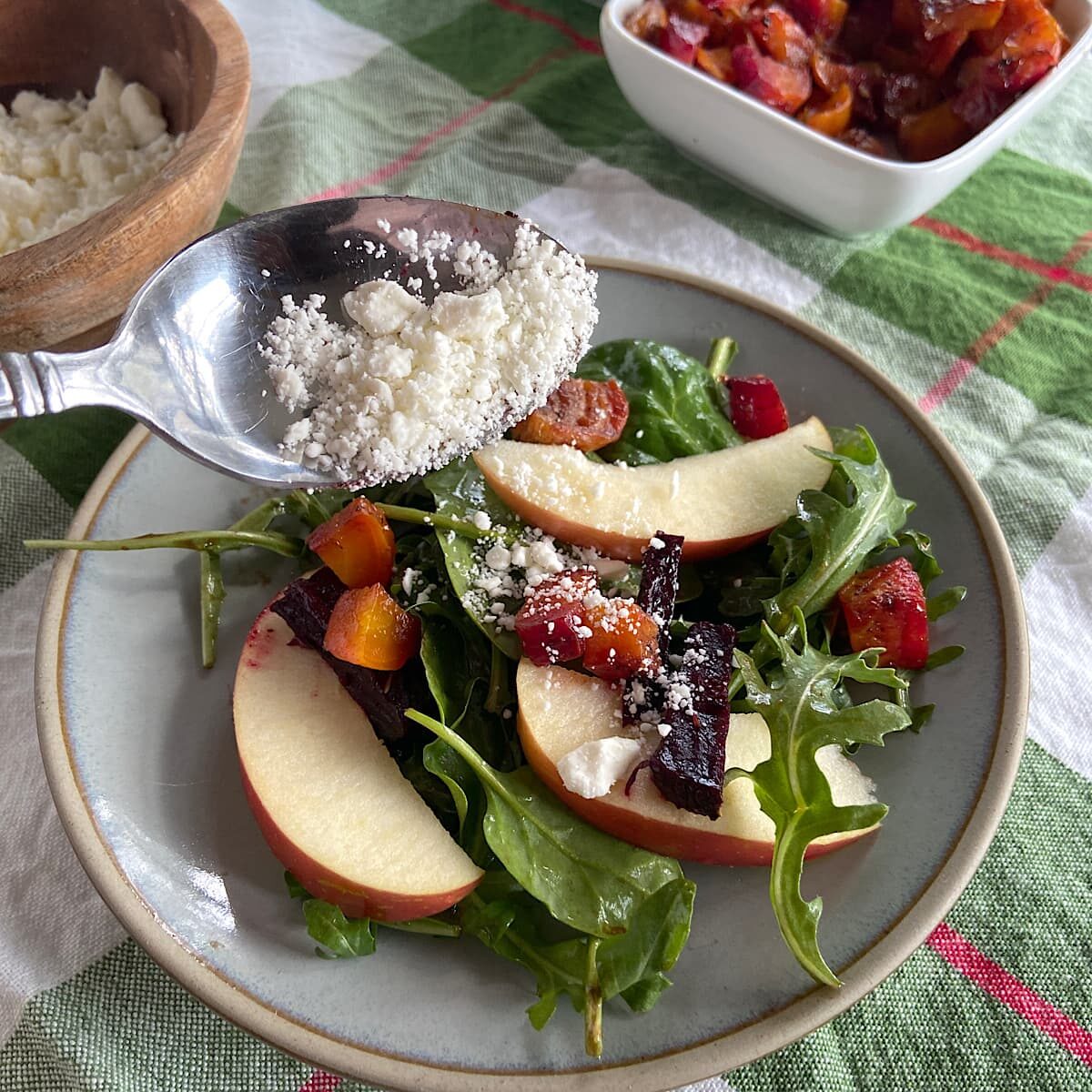 Sprinkle crumbled feta cheese over greens, apples, and beets.