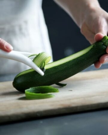 using hand peeler to peel zucchini