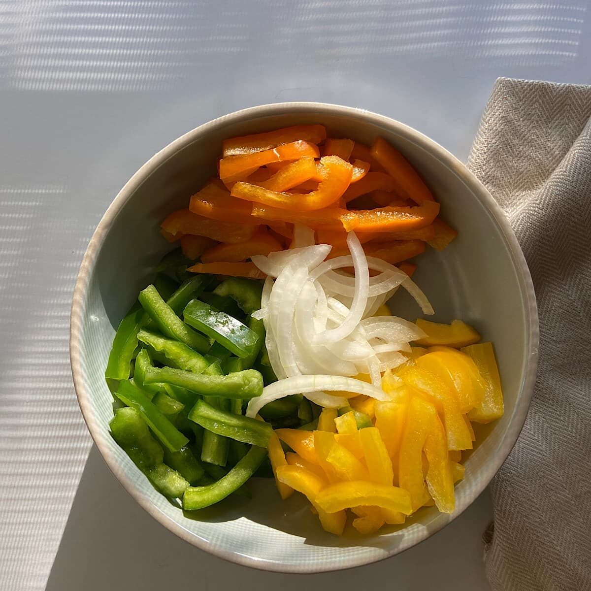 bowl of chopped pepper and onion strips