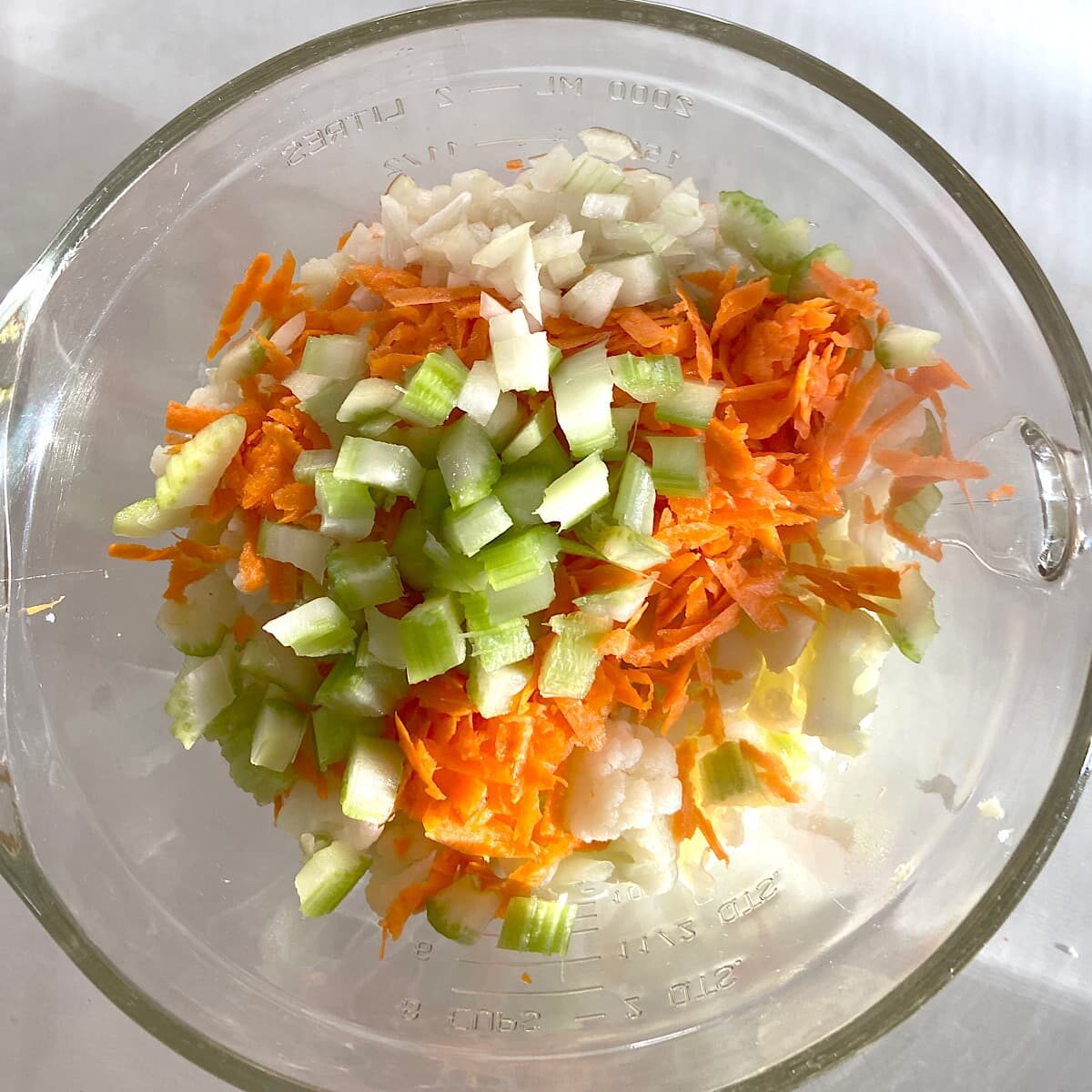 ingredients for cauliflower potato salad in glass bowl