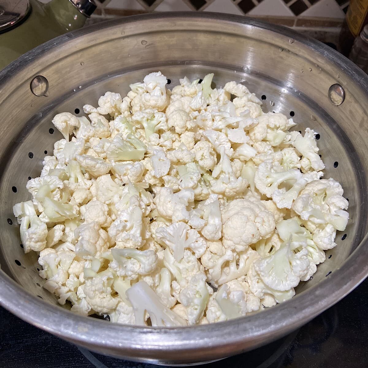 Chopped Cauliflower pieces in steamer basket