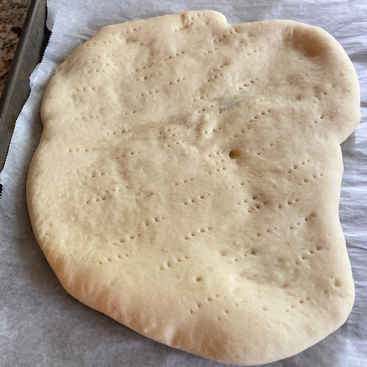 Half prebaked Pizza Crust ready for toppings.