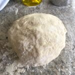ball of dough on floured counter