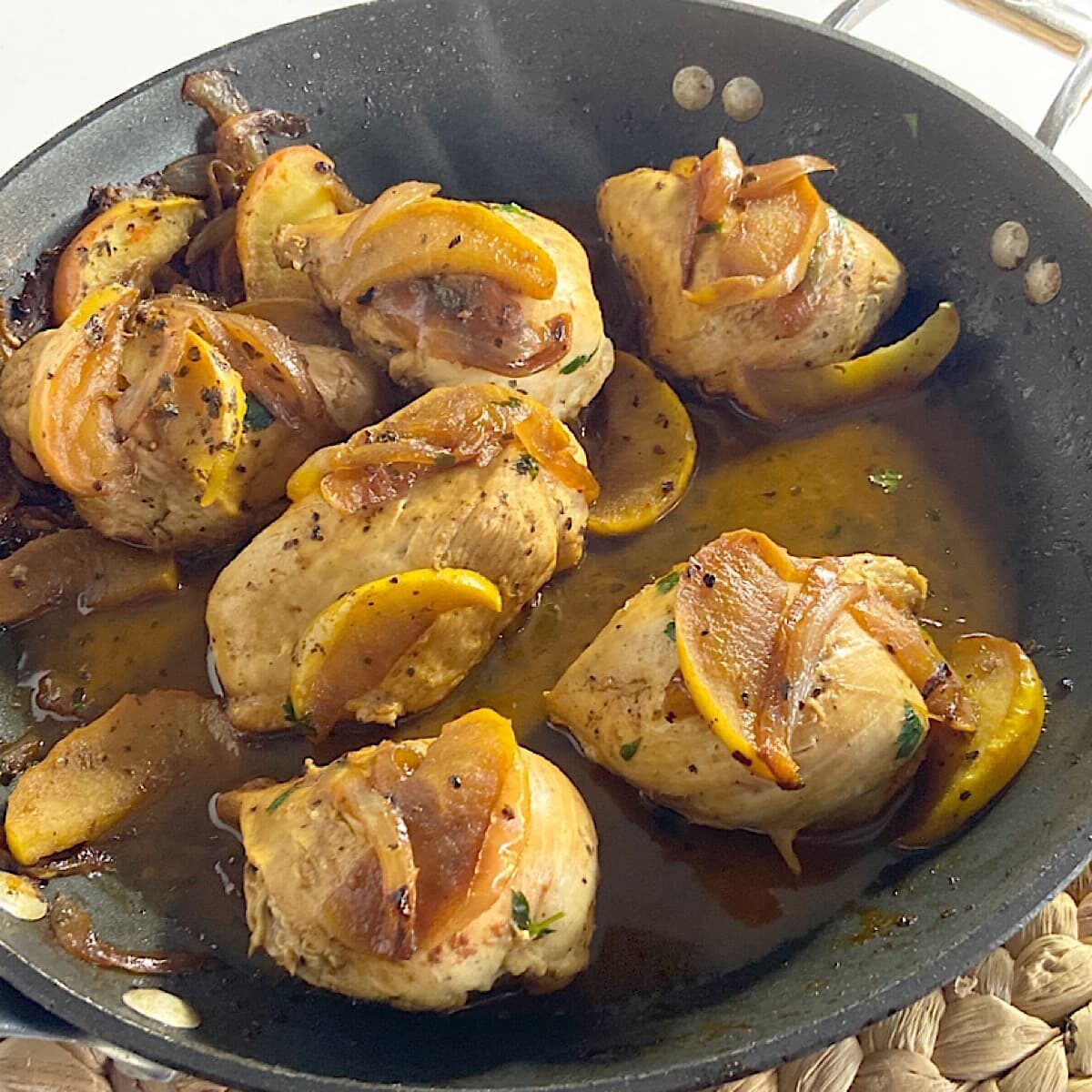 pan of sauteed chicken with apples and onions