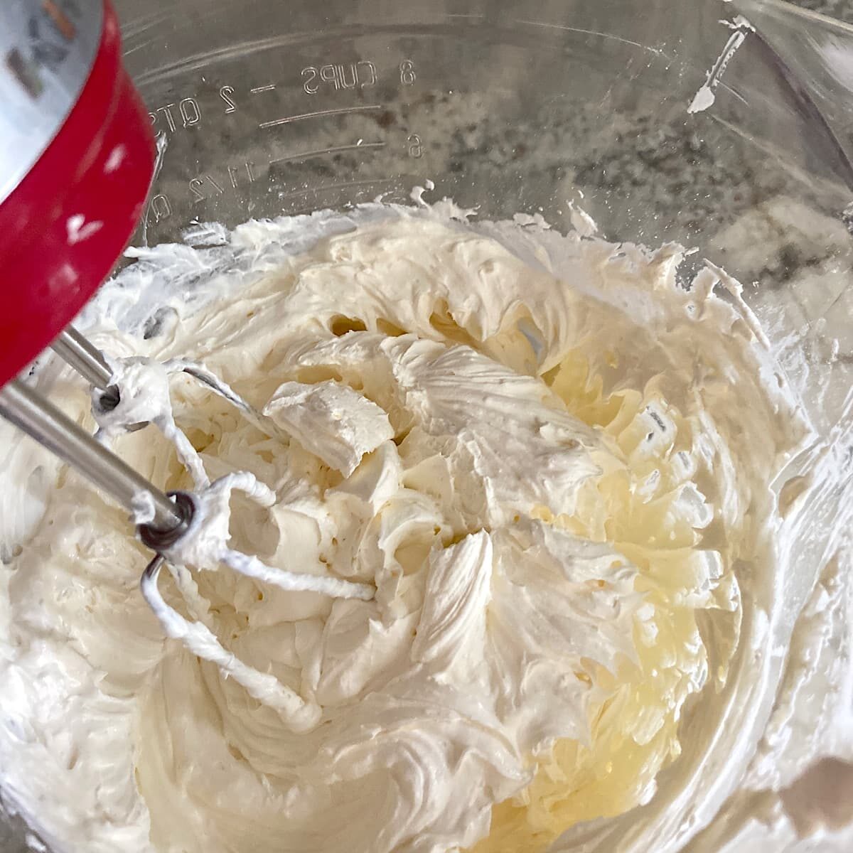 Picture of mixing whipped topping into cream cheese and powdered sugar mixture. 