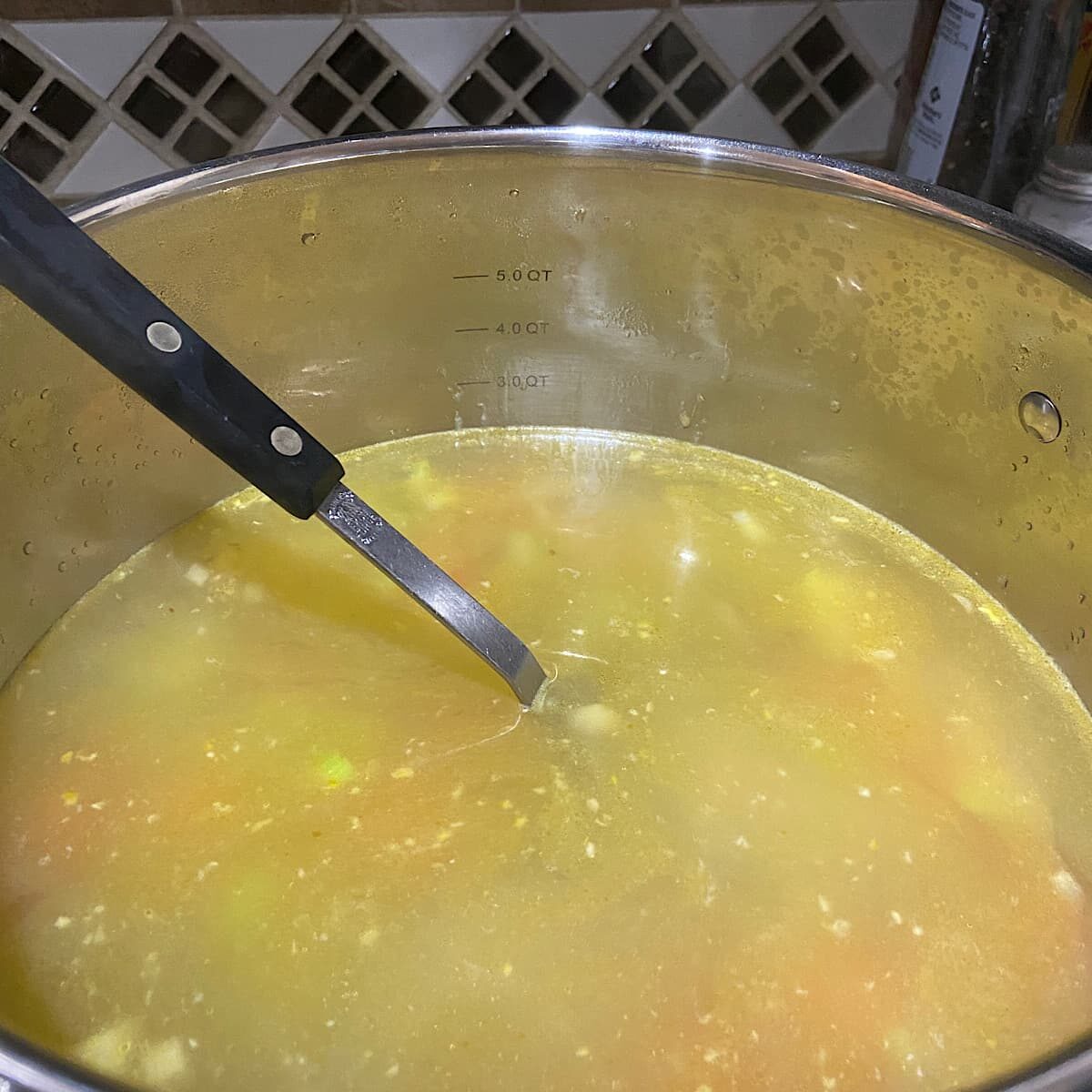 Add broth and potatoes to vegetables.