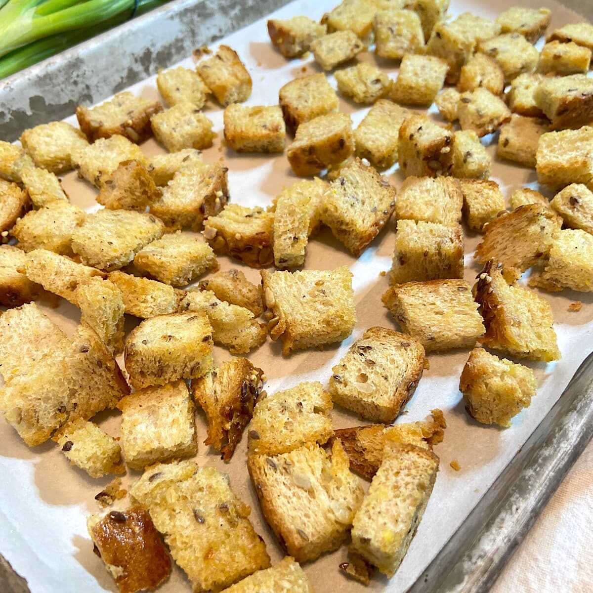 whole wheat croutons on baking tray. 