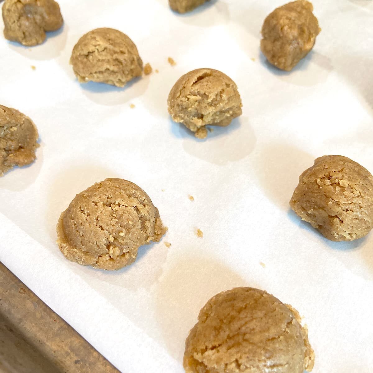 ball of spice cookie dough on baking sheet.