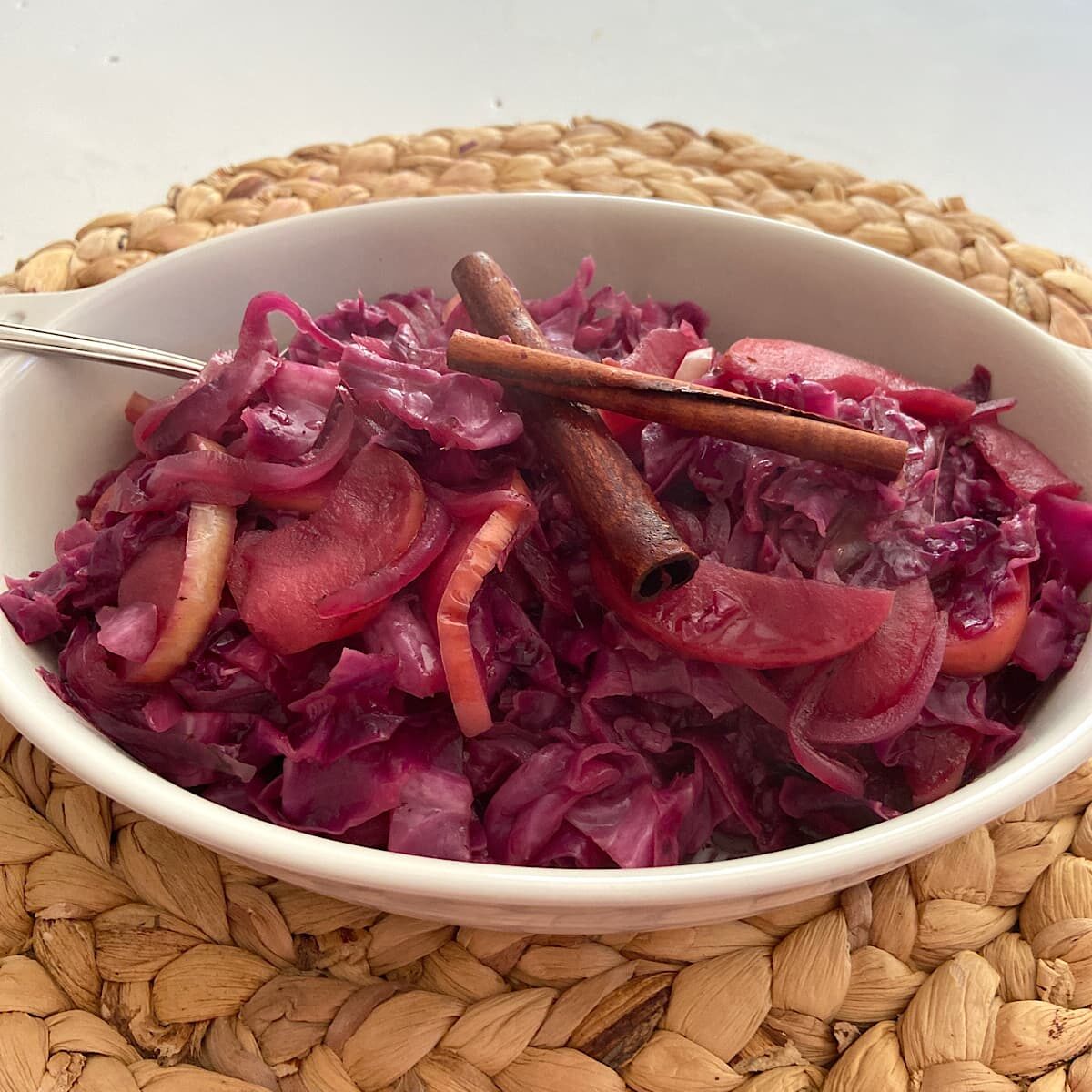 Red cabbage in a dish with apple and onion.