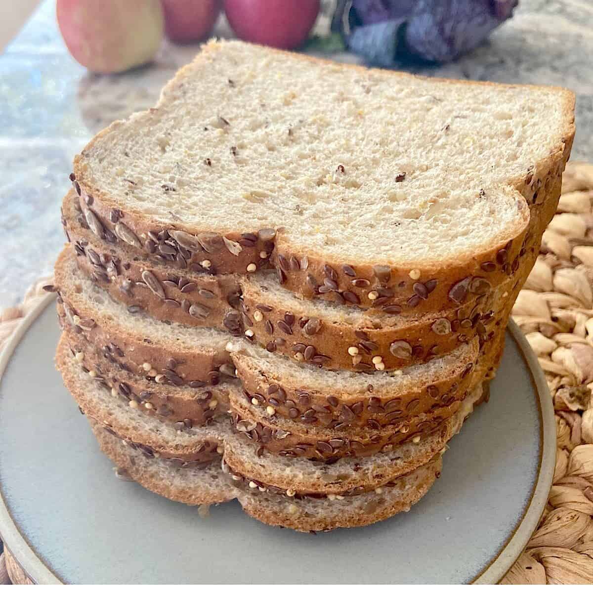 6 slices of whole grain bread on a plate.