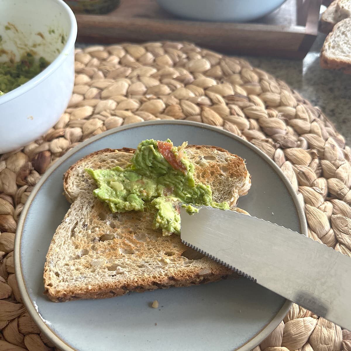 picture of spreading smashed avocado on toast.