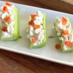 picture of dill cream cheese spread on celery logs.